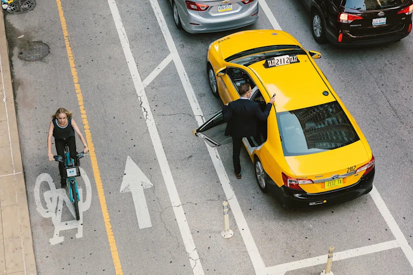17 chicago lifestyle woman on bicycle man entering taxi 1 1 blog.jpg