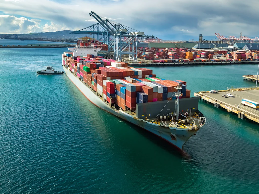 A large container ship docks at a shipping port.