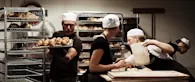 Bakers at Coopers Bakehouse in London, busy baking fresh loaves of bread and pastries. Image credit: Ester Keane Photography.
