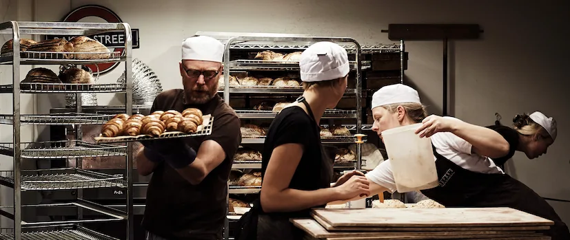 Bakers at Coopers Bakehouse in London, busy baking fresh loaves of bread and pastries. Image credit: Ester Keane Photography.