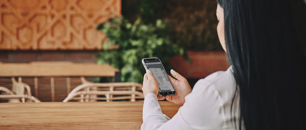 person looking at indoor position on mobile phone indoors