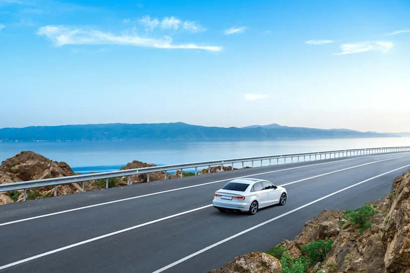 Car driving along a coast