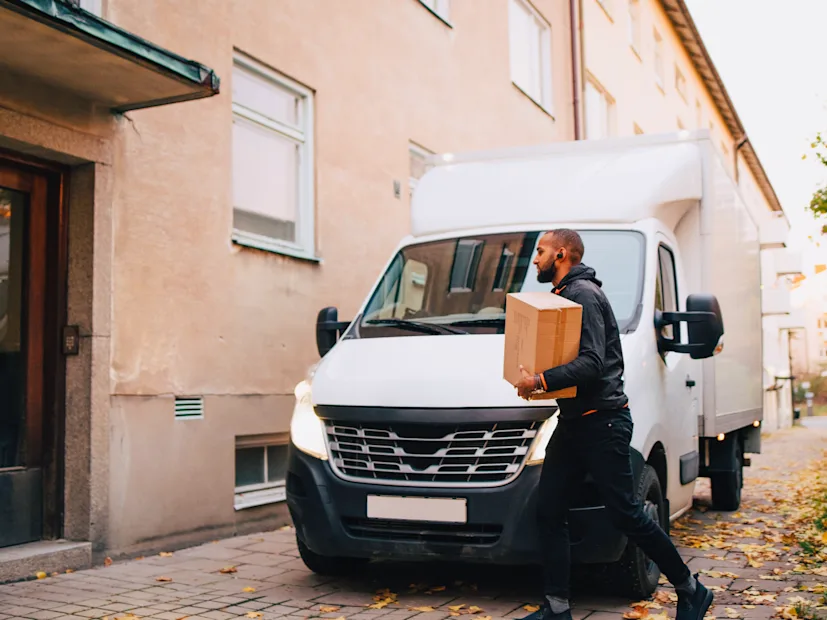 A driver delivers a package to a customer's door.