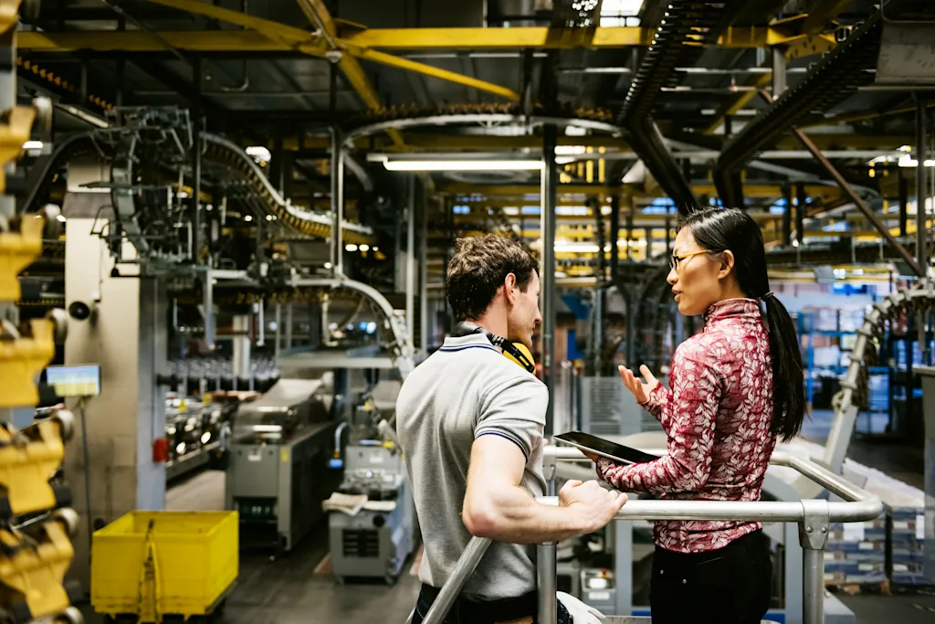 Workers assesing car in factory