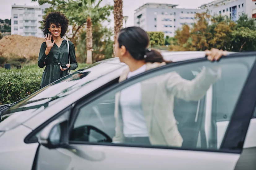 women woman driver ev electric vehicle car connected driving urban mobility.png
