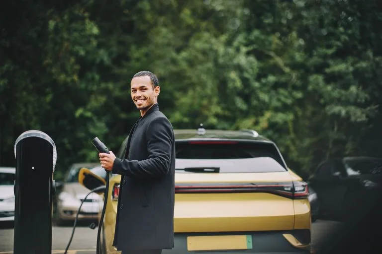 man electric car vehicle charging station driver blog