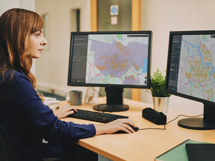 desk office woman maps supply chain routing.png