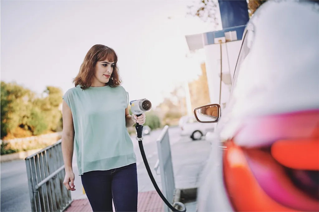 malaga ev electric vehicle woman charging station blog