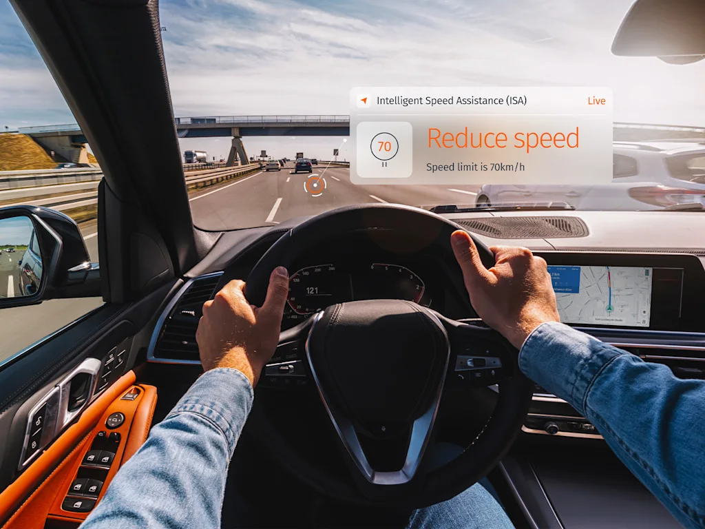 A driver's perspective of a digital dashboard displaying intelligent speed assistance.