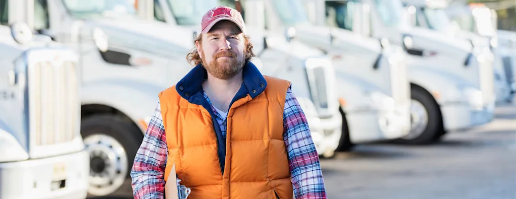 Man in front of trucks