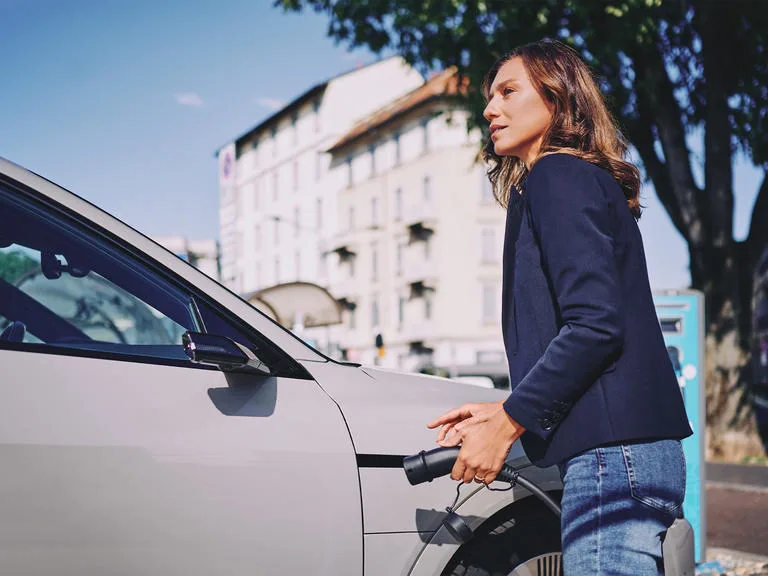 woman electric vehicle car ev charging charge point index 2023