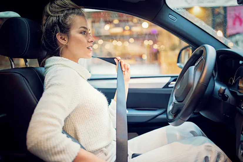young woman fastening her seat belt blog.jpg